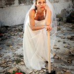 bride in smashed-up house holding sledge-hammer